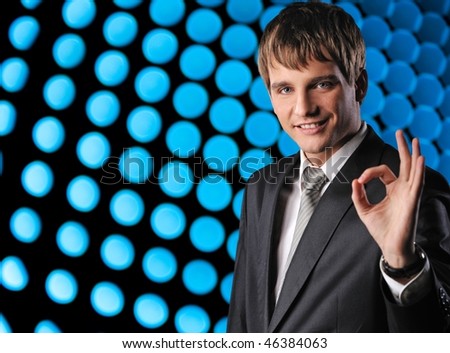 Young happy businessman over abstract background