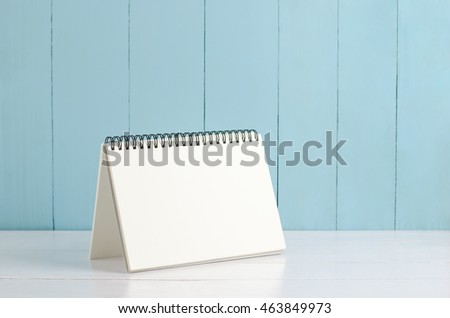 Blank desk calendar on white and blue wooden background, Blank notebook on wooden table Royalty-Free Stock Photo #463849973