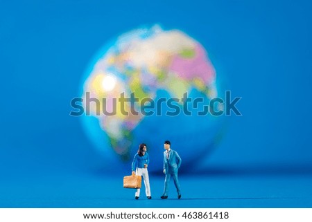 Globe and miniature businessmen