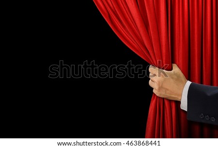 Hand open stage red curtain on black background Royalty-Free Stock Photo #463868441