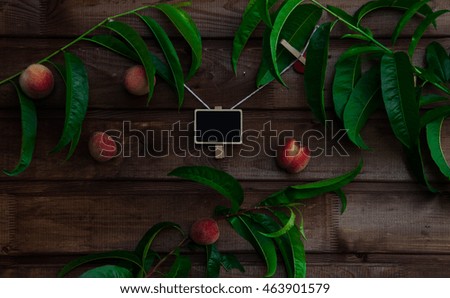 Fresh, cold peach tea with mint, ice cubes and peaches fruits on wooden background.