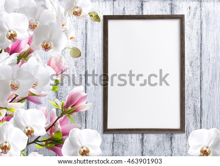 Magnolia flowers with orchidea and motivational frame  for your text or picture on background of white wooden planks in scandinavian style
