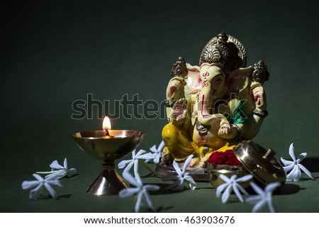 Hindu God Ganesha. Ganesha Idol. A colorful statue of Ganesha Idol on dark background. space for text or headline.