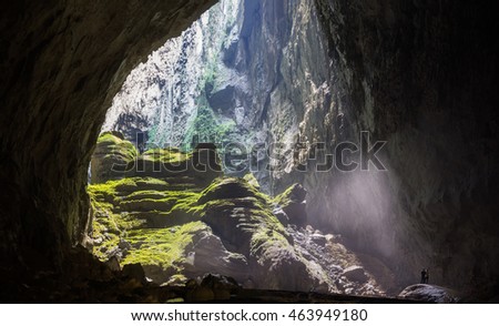 Mystery cave entrance with rocks, mist, green trees in Son Doong Cave, the largest cave in the world in UNESCO World Heritage Site Phong Nha-Ke Bang National Park, Quang Binh province, Vietnam
