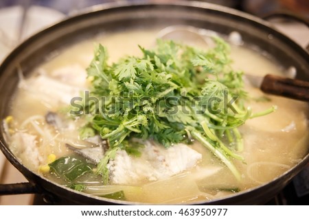 Haemul Sundubu Jjigae boiling eafood Soft tofu fish stew served in claypot at the Noryangjin Fisheries Wholesale Market with green vegetable as garnish