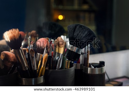 Professional makeup brushes set closeup near salon mirror Royalty-Free Stock Photo #463989101