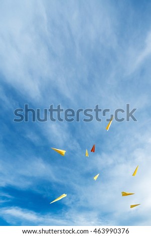 yellow and orange aircraft rocket paper floating in beautiful blue sky. Text space.