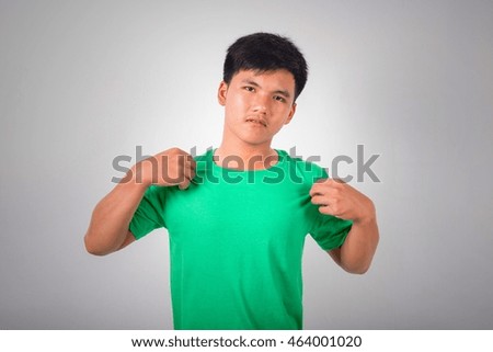 A man in green shirt scratches himself because of itching