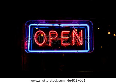 neon "open" sign welcomes customers inside