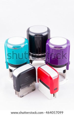 Automatic hand-stamps different colors on white background