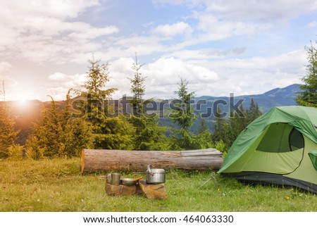 Camping in the mountains with the collected mushrooms and cooking facilities. Royalty-Free Stock Photo #464063330
