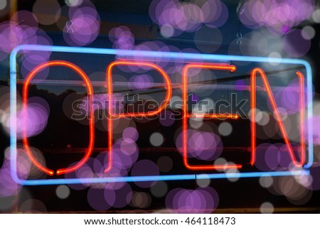 close up neon open sign on storefront window