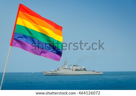 A gay flag and navy ship in the background with copy space