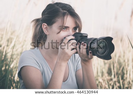 Vintage portrait of a beautiful young woman who likes to take pictures of nature