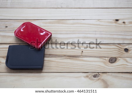 Red  external hard drive on wooden background 