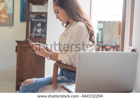 A beautiful happy young woman using a laptop computer shopping on line using her credit card