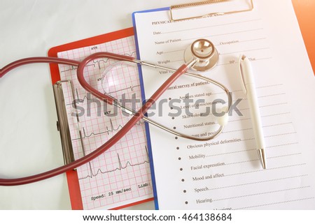 Selective focus Stethoscope on a medical chart on the nurse station in the hospital. Blurred background.