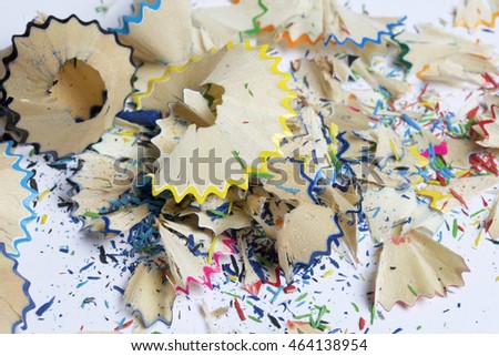 Colored pencil shavings from sharpened, located on a white background.