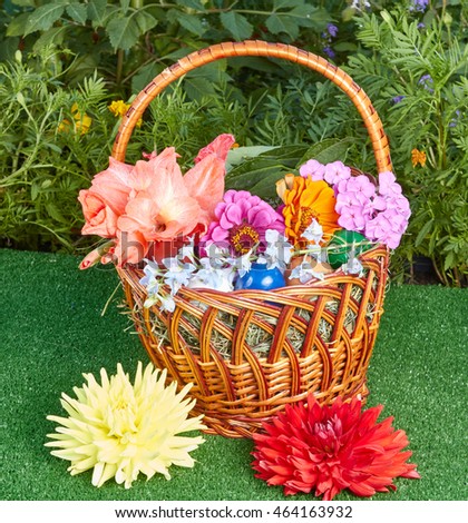 Easter basket with fresh flowers and colored eggs