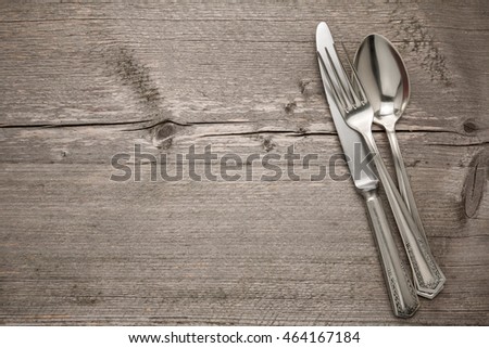 Cutlery is in a napkin wrapped on an old table Royalty-Free Stock Photo #464167184