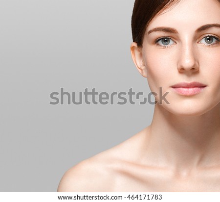 Beauty Spa Woman with perfect skin Portrait. Beautiful Brunette closeup face on gray background