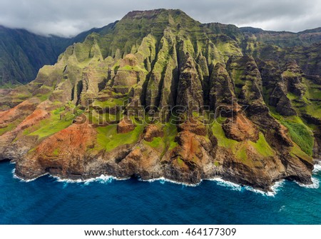 View of the monumental Na Pali Coast at Puanaiea Point and The Bright Eye, aerial shot from a helicopter, Kauai, Hawaii.