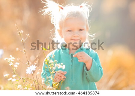 happy little girl spend time in autumn forest