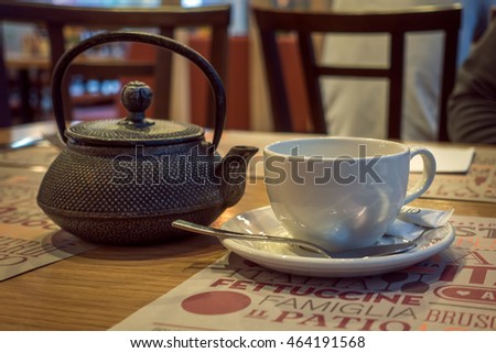 Cafe Table With Tea Kettle And White Cup