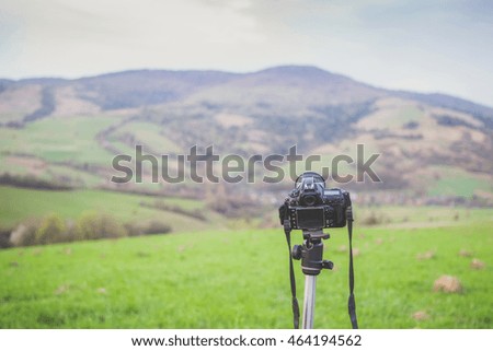 Professional camera on tripod on mountain background. Carpathians, Ukraine