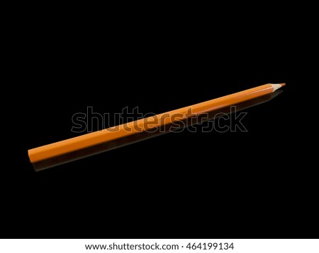 Red coloring pencil with reflection over black background