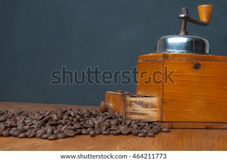 Coffee grinder on wooden background.