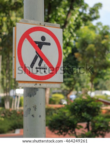 Signs banned skateboarding in the park.