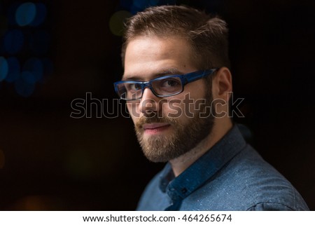 a portrait of a young, attractive man looking at the camera