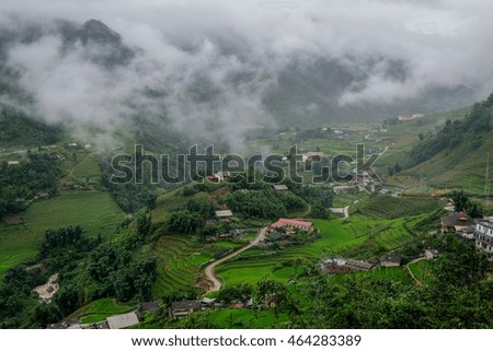 Rice terrace village and huge fog from heavy rain with big mountain surrounded, the picture is quite dark and suitable for white text or object