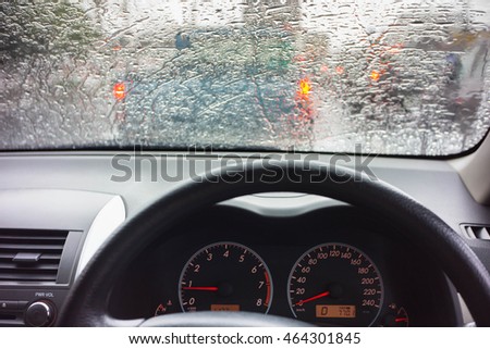 The image of the windshield on the streets and highways, everything is blurred because of rain.