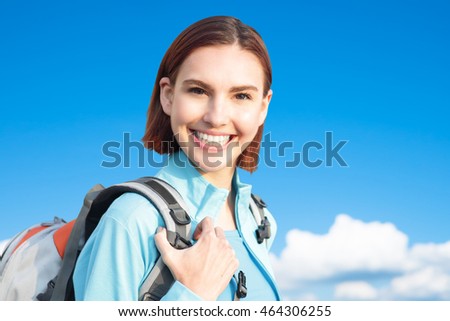 happy woman mountain hiker go to travel and take a selfie with blue sky and white clouds, caucasian