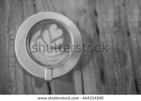Latte art foam heart picture hot coffee back and white color tone with clarity.