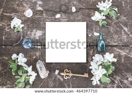 Stylish branding mockup with flowers to display your artworks. Cute vintage layout mock up on wooden background. Flat lay top view mockup.
