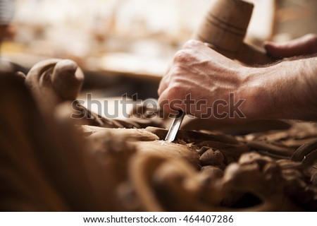 Hands of craftsman carve  with a gouge in the hands on the workbench in carpentry Royalty-Free Stock Photo #464407286
