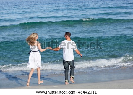 Loving couple walking together at the seaside
