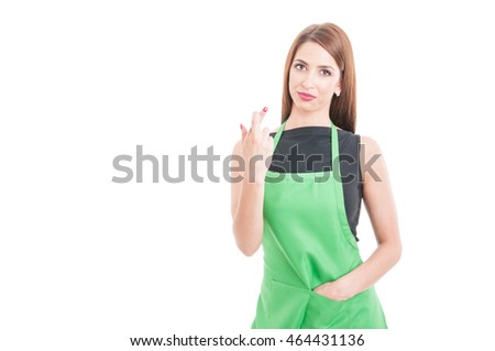 Beautiful and successful supermarket seller with luck sign on white background with copyspace