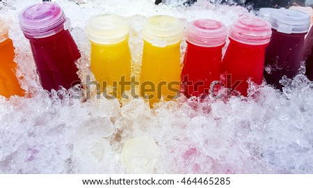 Many bottle of juice put on ice.