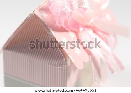 Pink and white sugared almonds in a house shape cartoon box