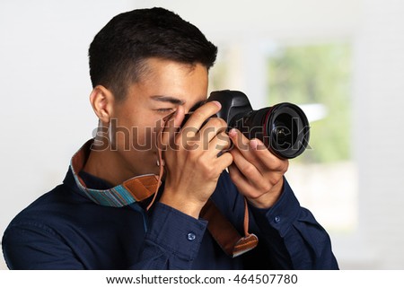Happy man taking pictures with digital camera