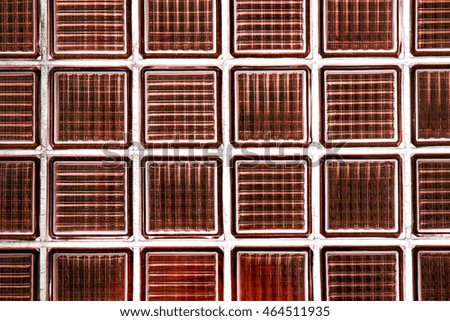 Decorative and glossy glass block window in orange as a texture or for background