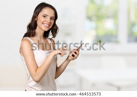 smiling beautiful woman texting with her phone