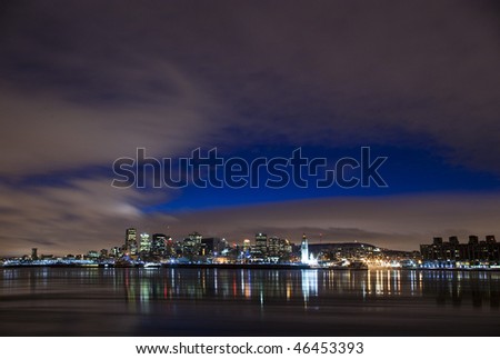 cityscape night scene Montreal Canada over river Saint Lawrence impressive and vibrant dusk sky skyscrapers lights