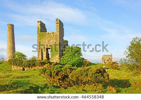 Cornwall's Industrial heritage, the rugged beauty of Bodmin Moor bathed in the golden glow of an early morning sun rise and the ruins of the Engine House of Wheal Jenkin mine, Cornwall, England, UK