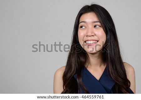 Portrait of happy young Asian woman smiling