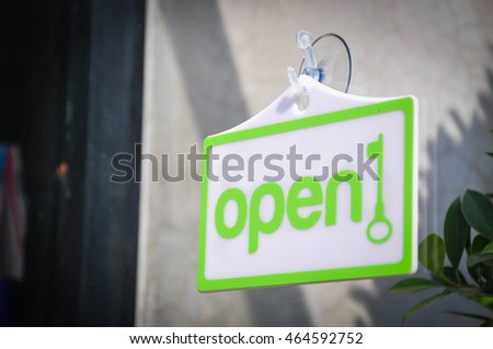Open sign broad on the glass of window at shop